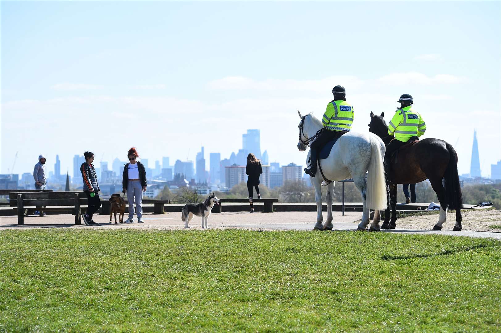 Police officers speaking to people on Primrose Hill in London on April 14 (Kirsty O’Connor/PA)