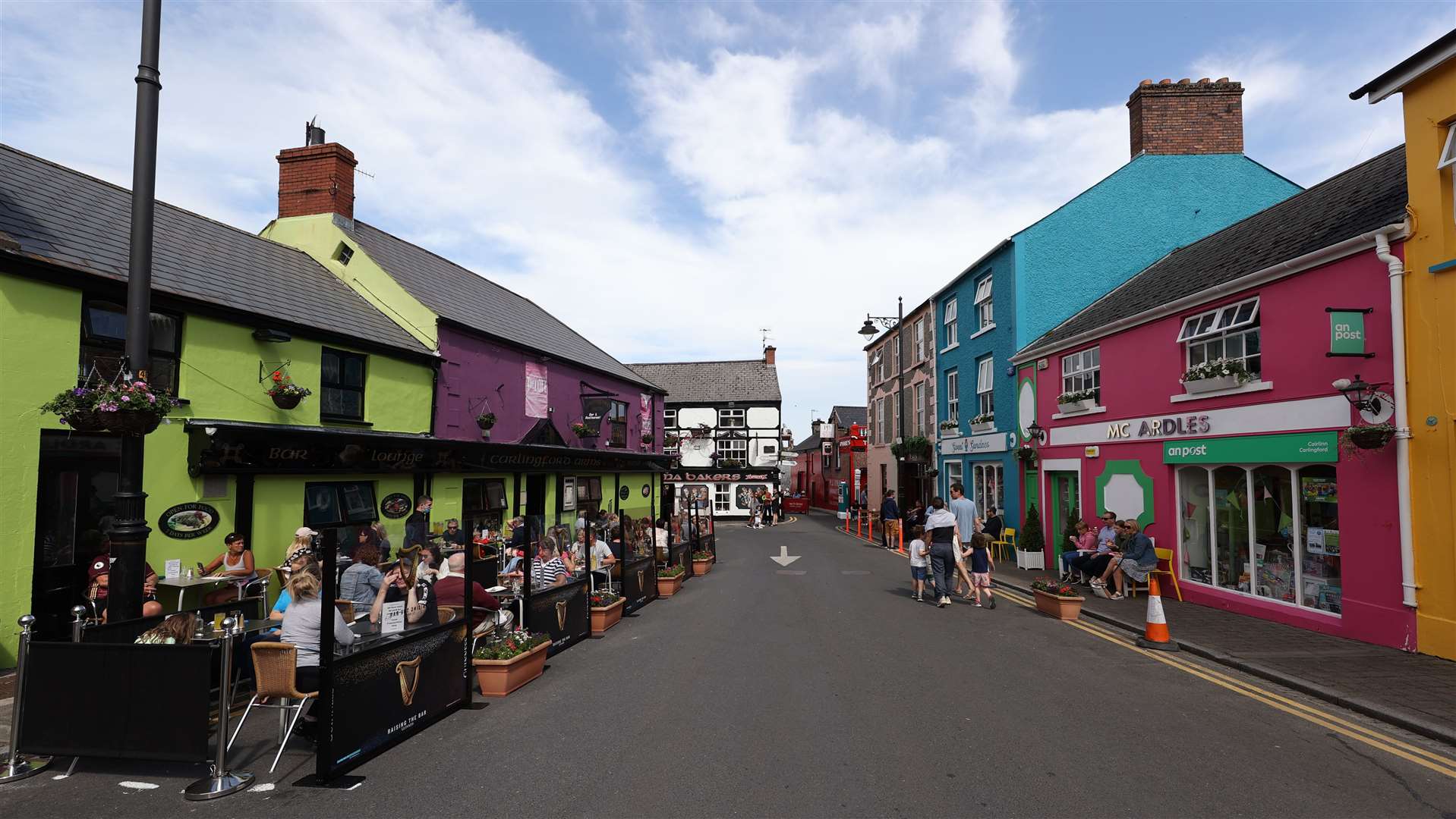 People enjoy drinks on Market Street in Carlingford (Liam McBurney/PA)