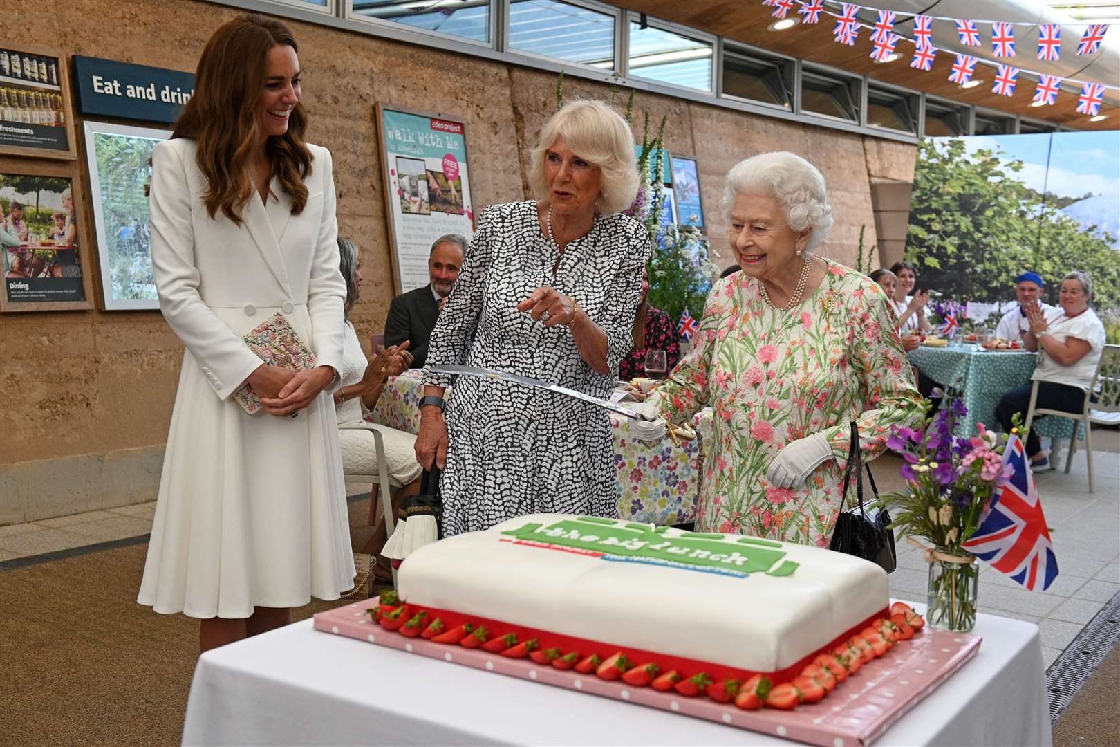 The Queen’s use of the sword amused Kate and Camilla (Oli Scarff/PA)