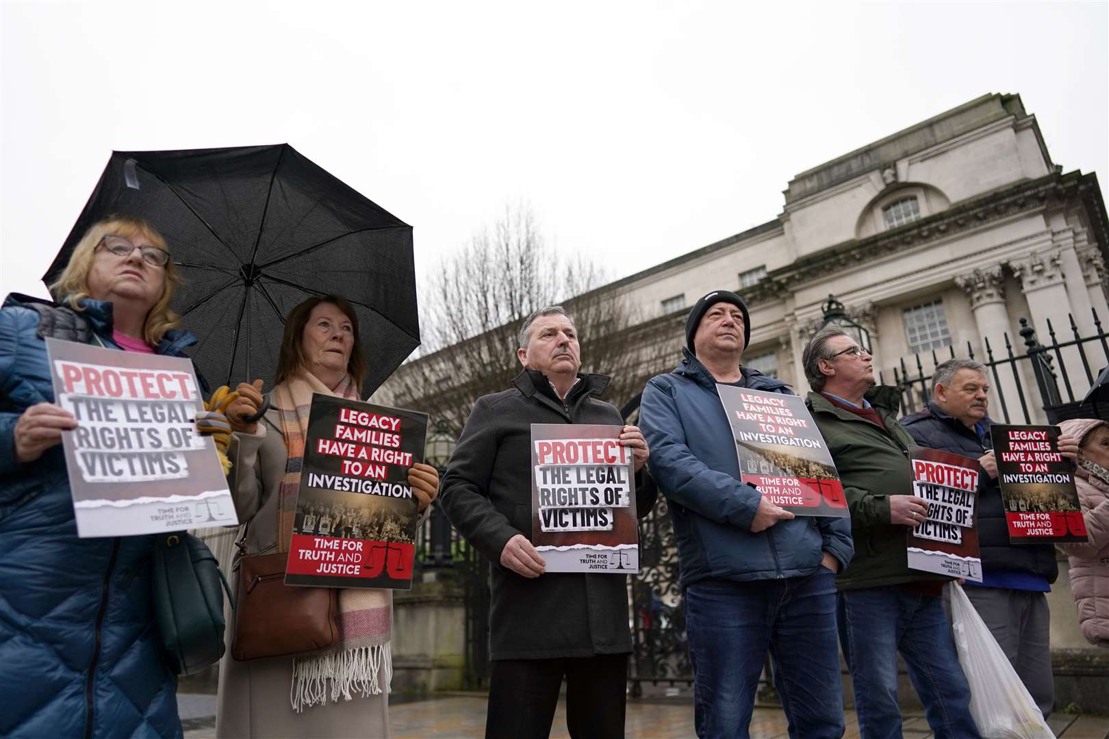 Campaigners outside Belfast High Court ahead of its decision in a landmark legal challenge to the UK government’s Troubles Act brought by several victims of the Northern Ireland conflict (Brian Lawless/PA)