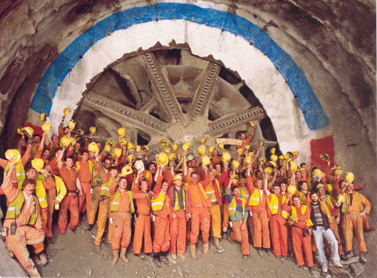 Jubilant workers celebrate as the huge boring machine used to build the Channel Tunnel ground its way through the last 300mm of chalk at Holywell shaft near Folkestone in 1990.