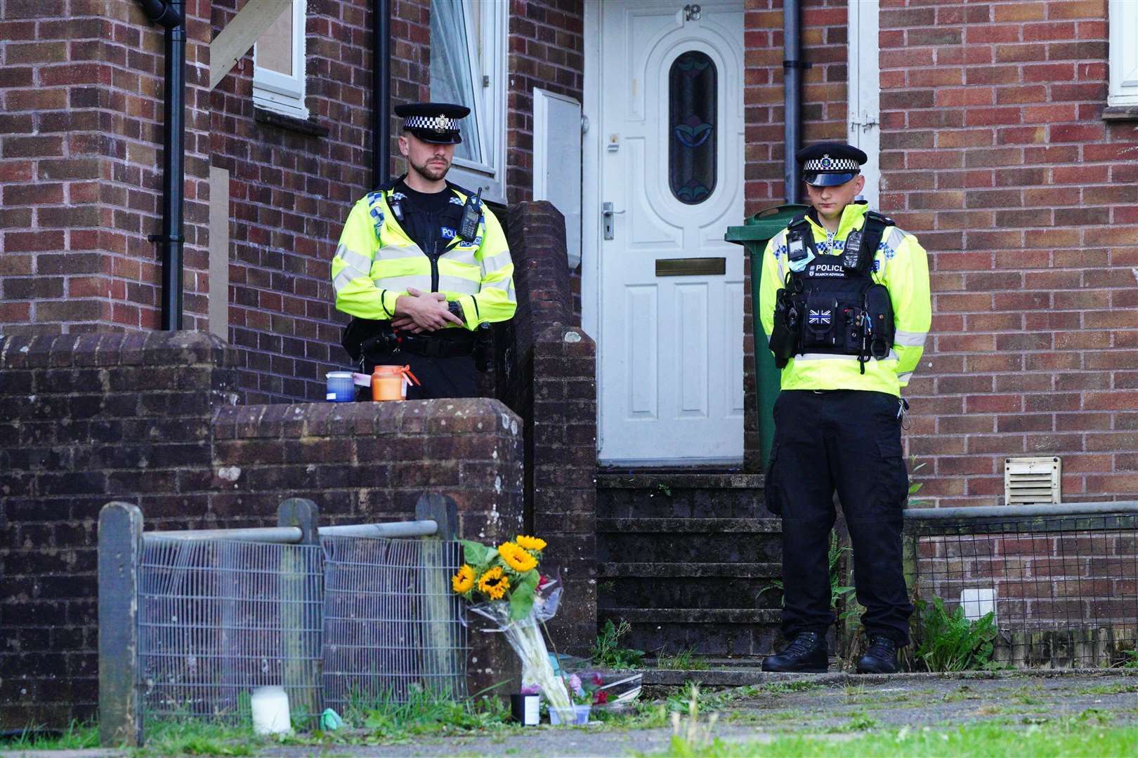 Floral tributes left outside the scene of the first shooting in Biddick Drive, Keyham (PA)