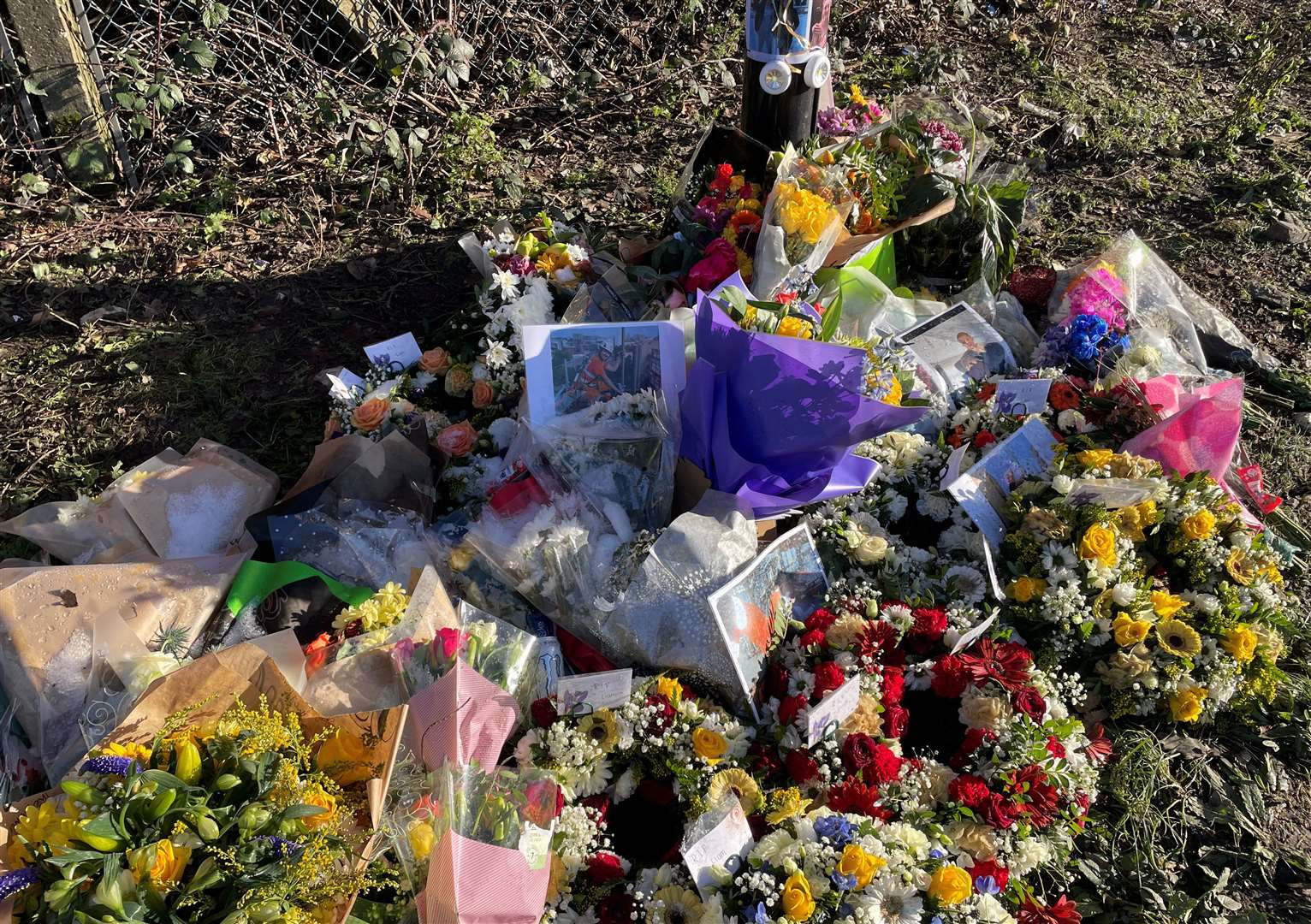 Flowers, pictures and balloons have been placed in Rochester Road