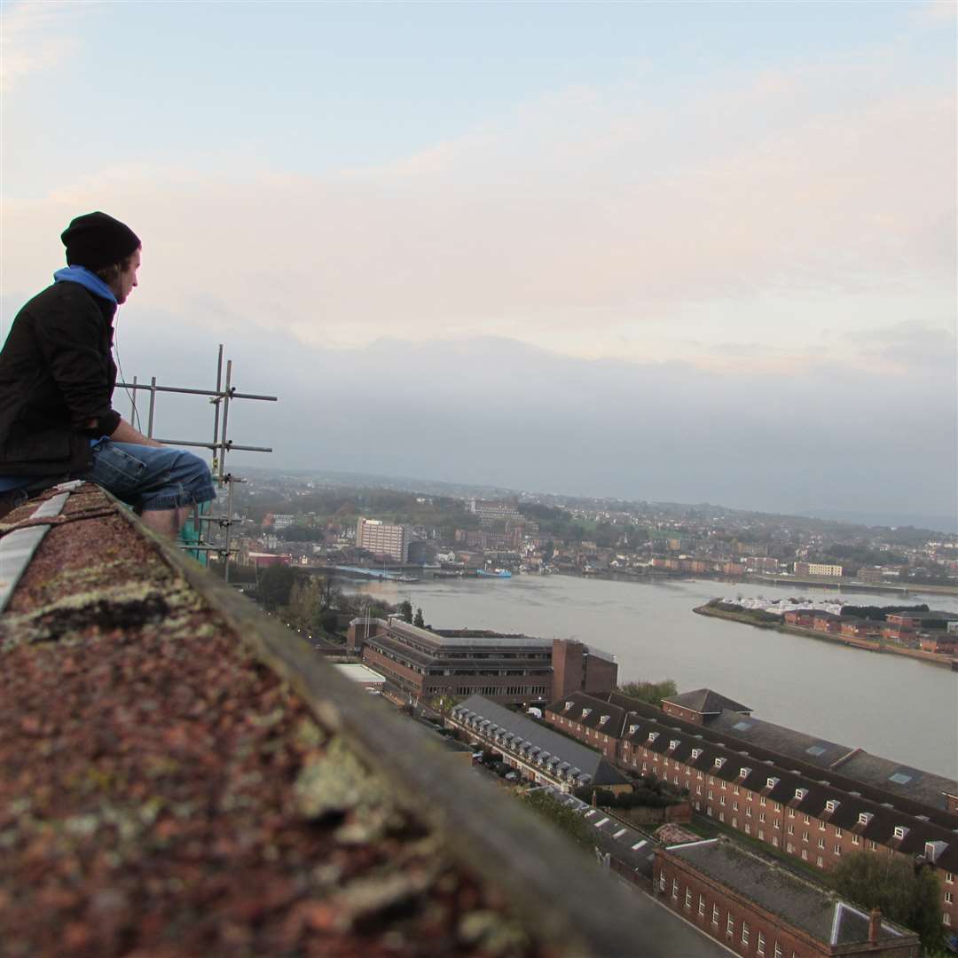 Urban climber "Straw" surveys the scene from a lofty perch above Brompton