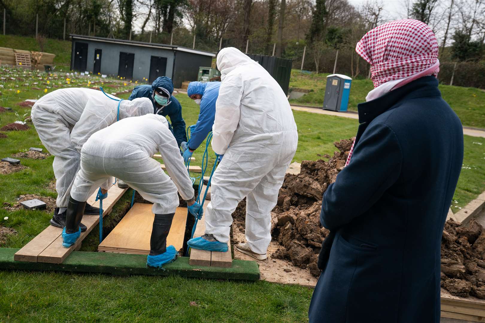 A mourner watches as Ismail’s coffin is lowered into the ground (Aaron Chown/PA)