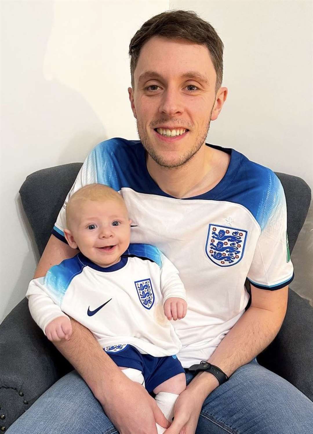 Jamie Nash, with his son Jude, dressed in England’s shirt from the World Cup in 2022 (Jamie Nash)