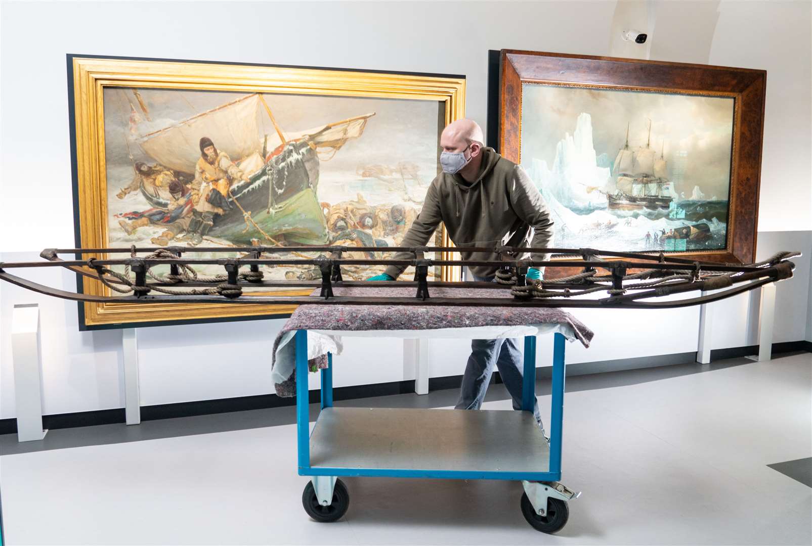 A member of museum staff with Ernest Shackleton’s sledge (Dominic Lipinski/PA)