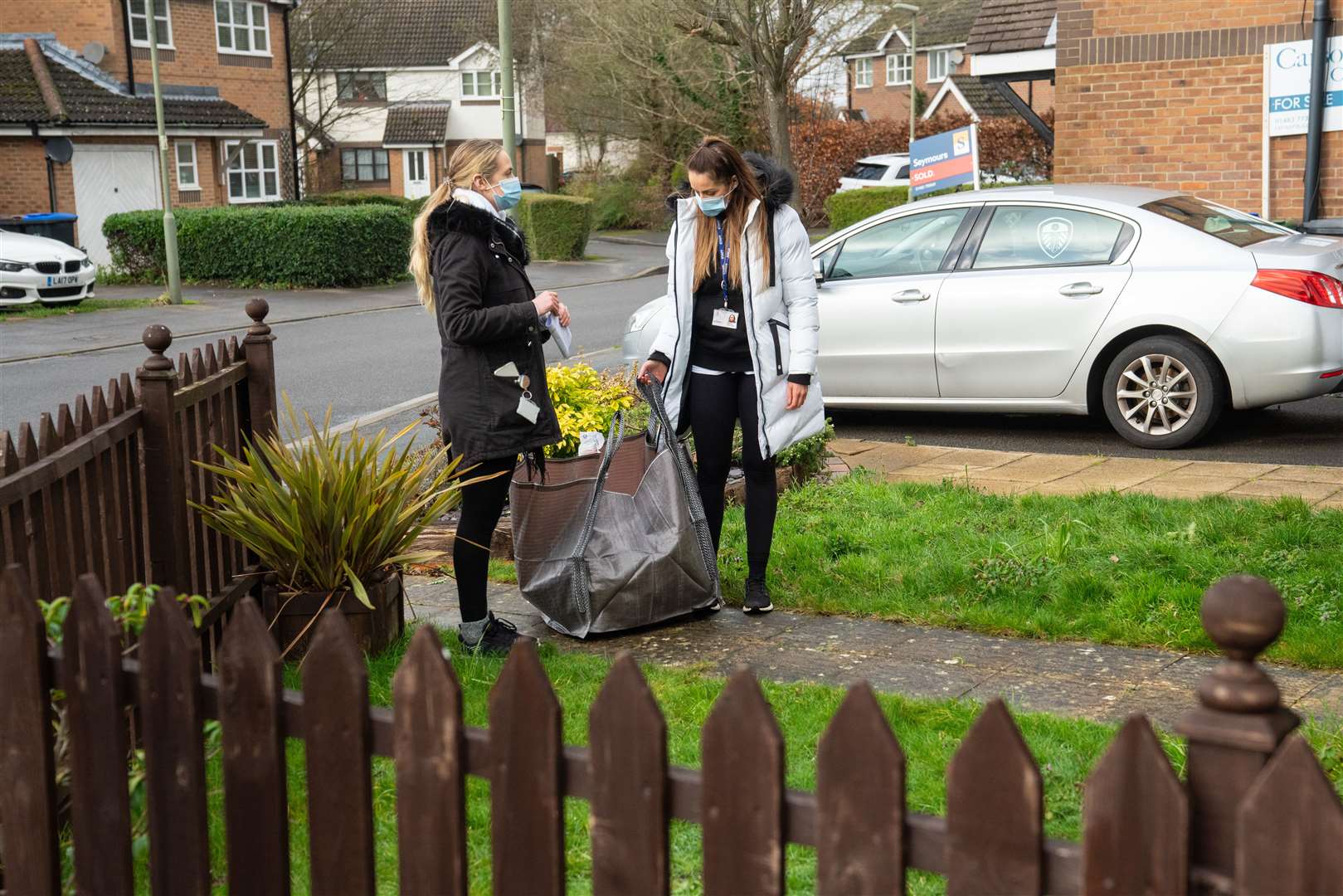 Volunteers deliver coronavirus test kits in Woking (Dominic Lipinski/PA)