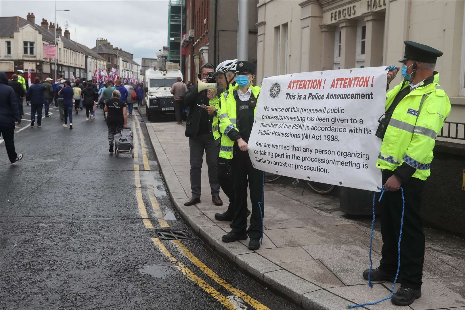 Police officers hold up a sign as loyalists take part in an anti-Northern Ireland Protocol rally in Portadown (Brian Lawless/PA)