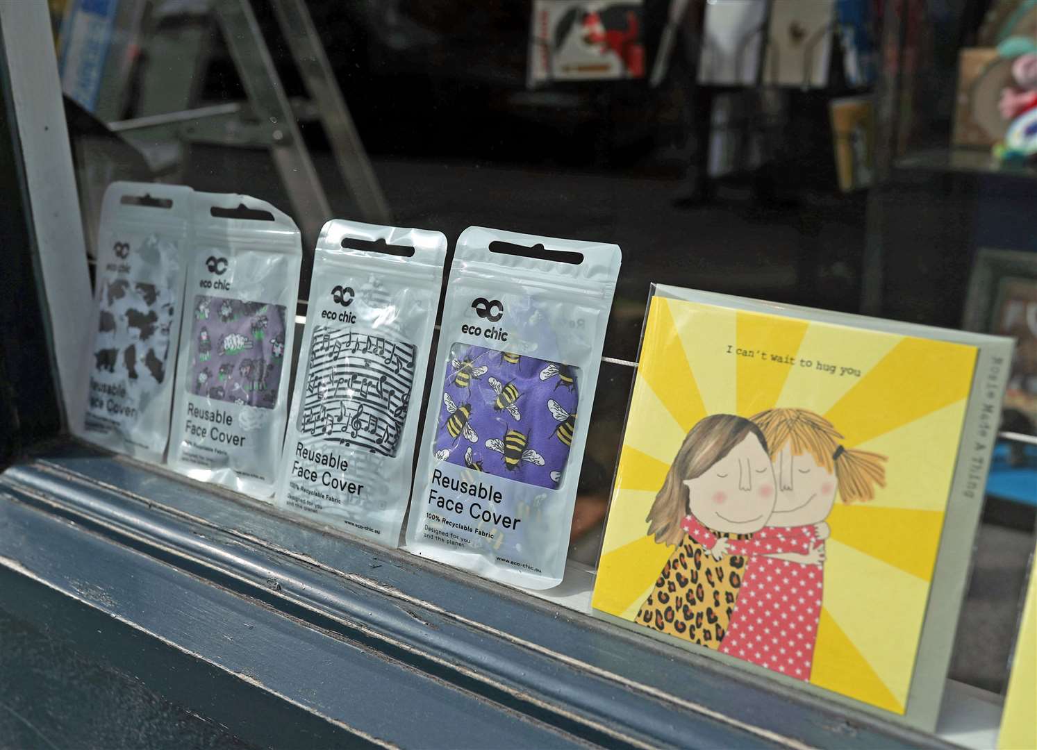 A greeting card shop in Islington, north London, displays reusable face covers in the window (Yui Mok/PA)