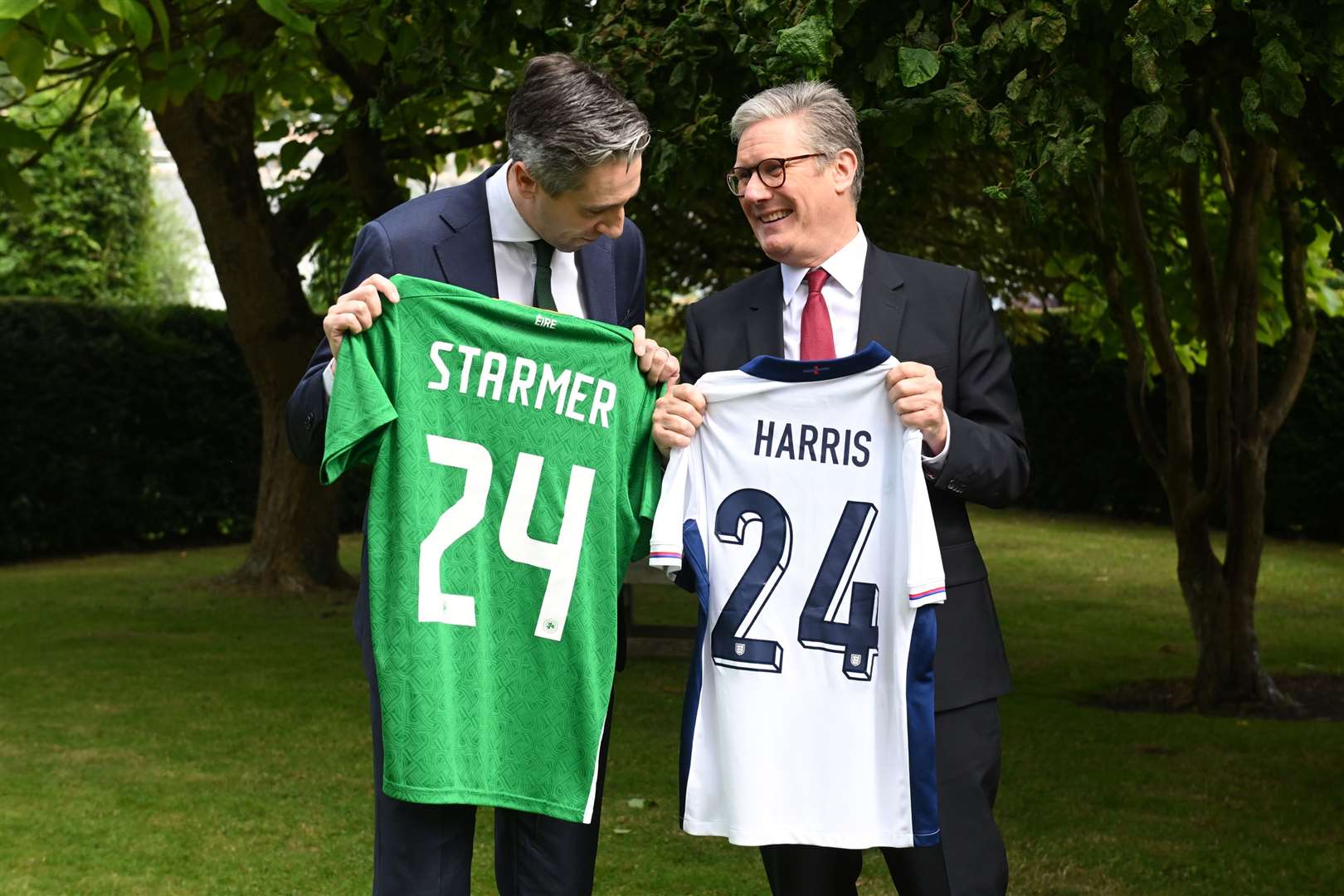 Taoiseach Simon Harris (left) and Prime Minister Sir Keir Starmer, hold up their respective national soccer teams shirts, with their names on their opposing teams shirts, at Farmleigh House, the official Irish state guest house in Dublin, ahead of the Republic of Ireland v England football match in the Irish capital. Picture date: Saturday September 7, 2024.