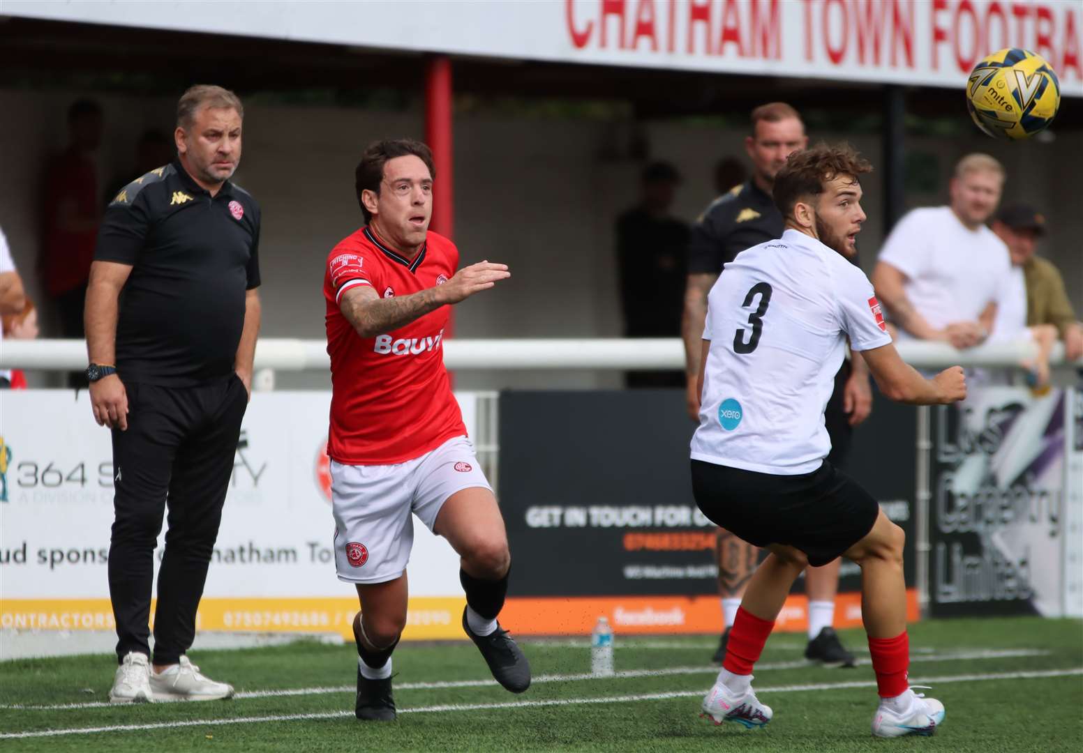 Chatham captain Jack Evans in the thick of it with Lewes' Harvey Hughes as Chats manager-chairman Kevin Hake watches on Picture: Max English @max_ePhotos