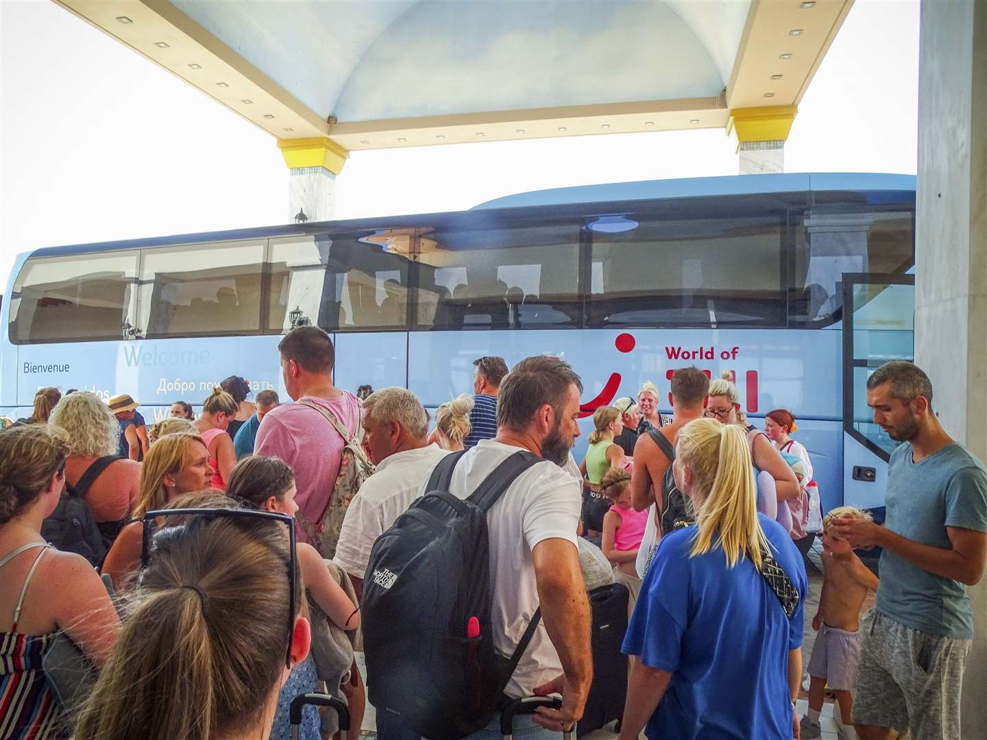 Evacuees wait to get on buses as they leave their hotel during a forest fire on the island of Rhodes on Sunday (Argyris Mantikos/Eurokinissi/AP)