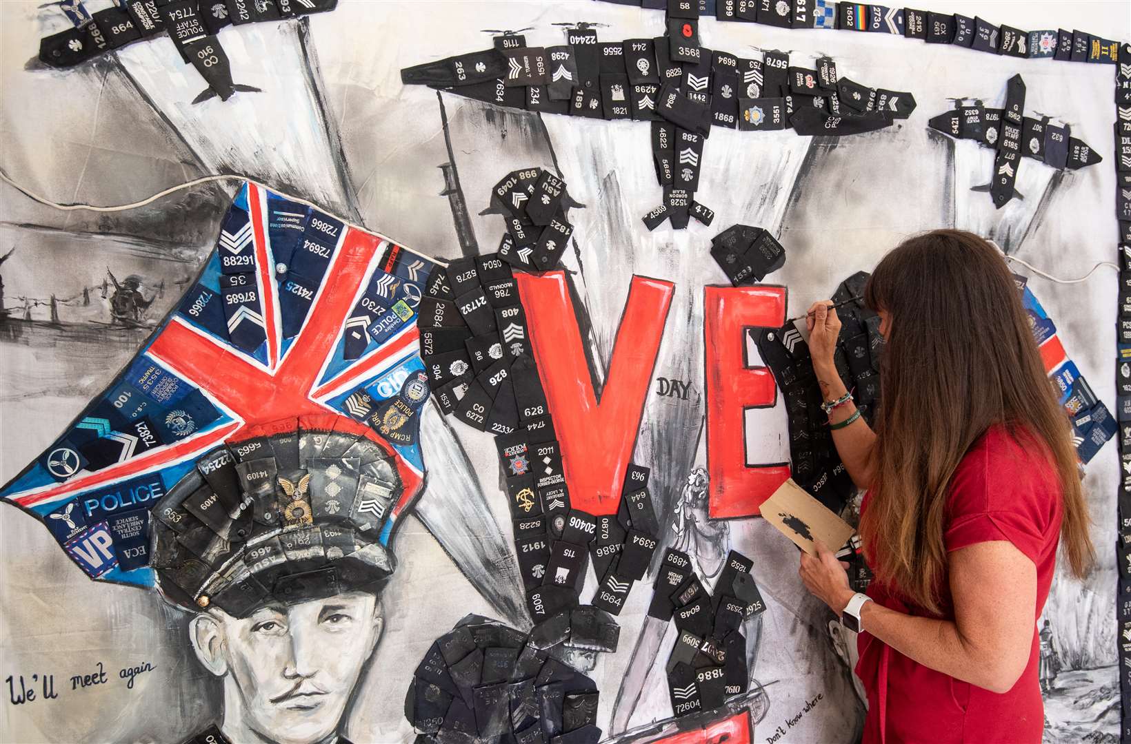 Sam Bailey painted a mural featuring Captain Tom Moore to mark the 75th anniversary of VE Day on Friday(Joe Giddens/PA)