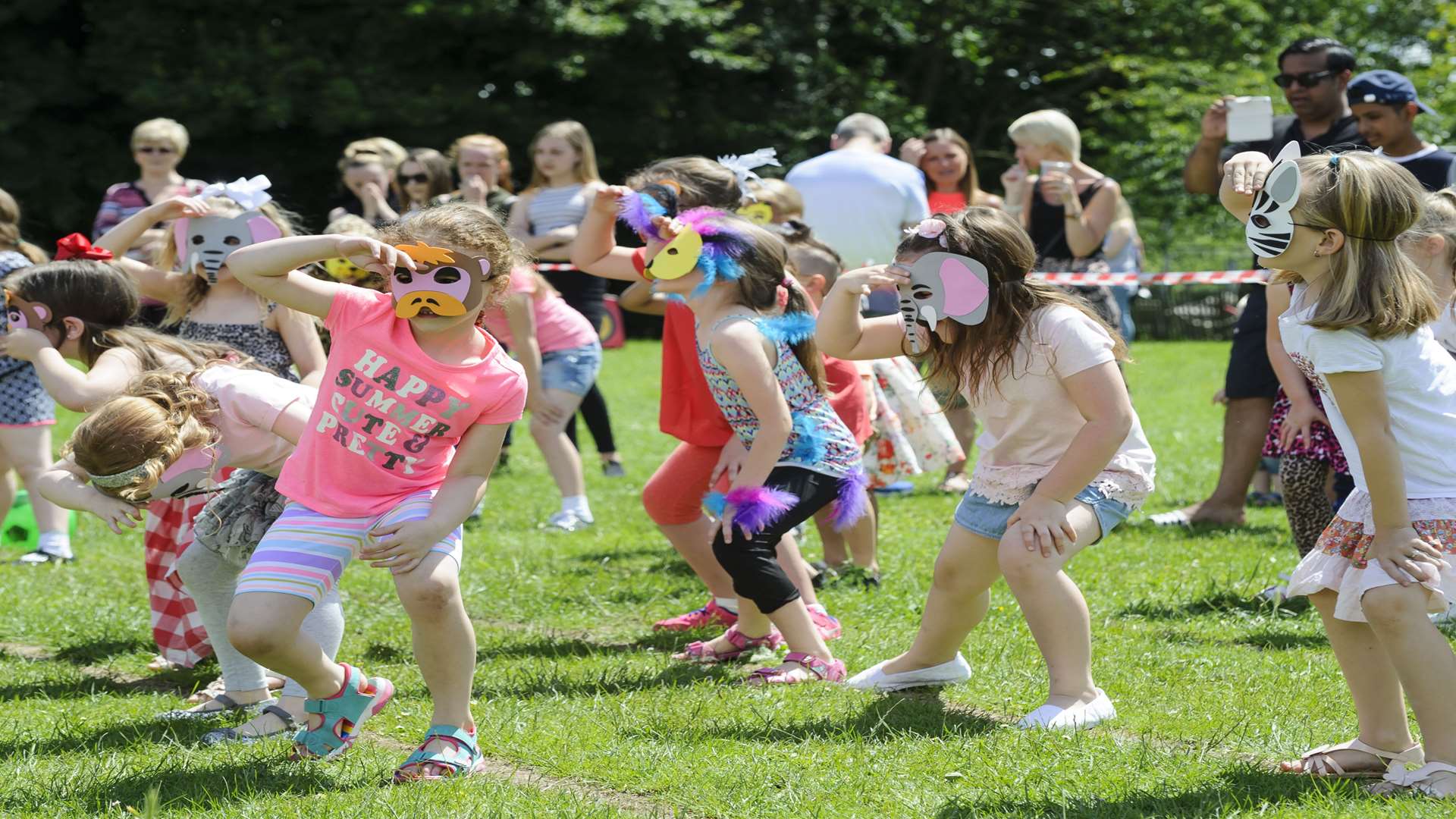 Children dance to the Bear Necessities at the school fair.