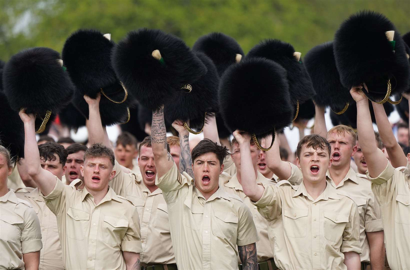 Members of the Welsh Guards remove their headdresses as they give three cheers for the King (Andrew Matthews/PA)