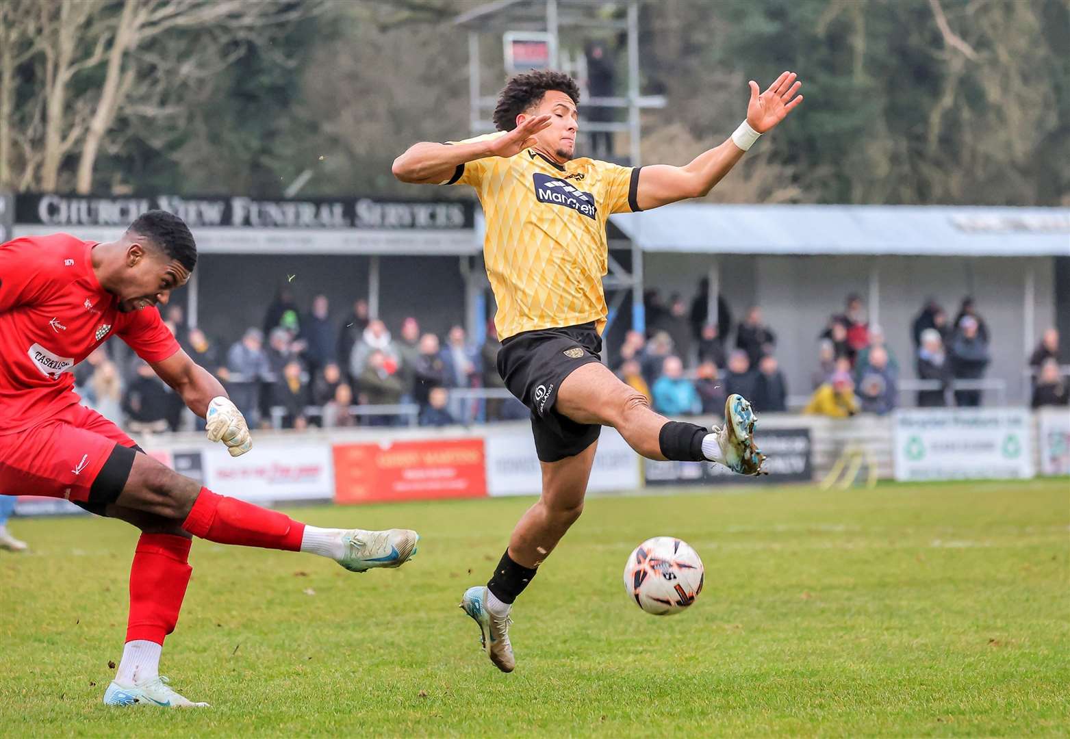 Sol Wanjau-Smith charges down a clearance from the Chesham keeper. Picture: Helen Cooper