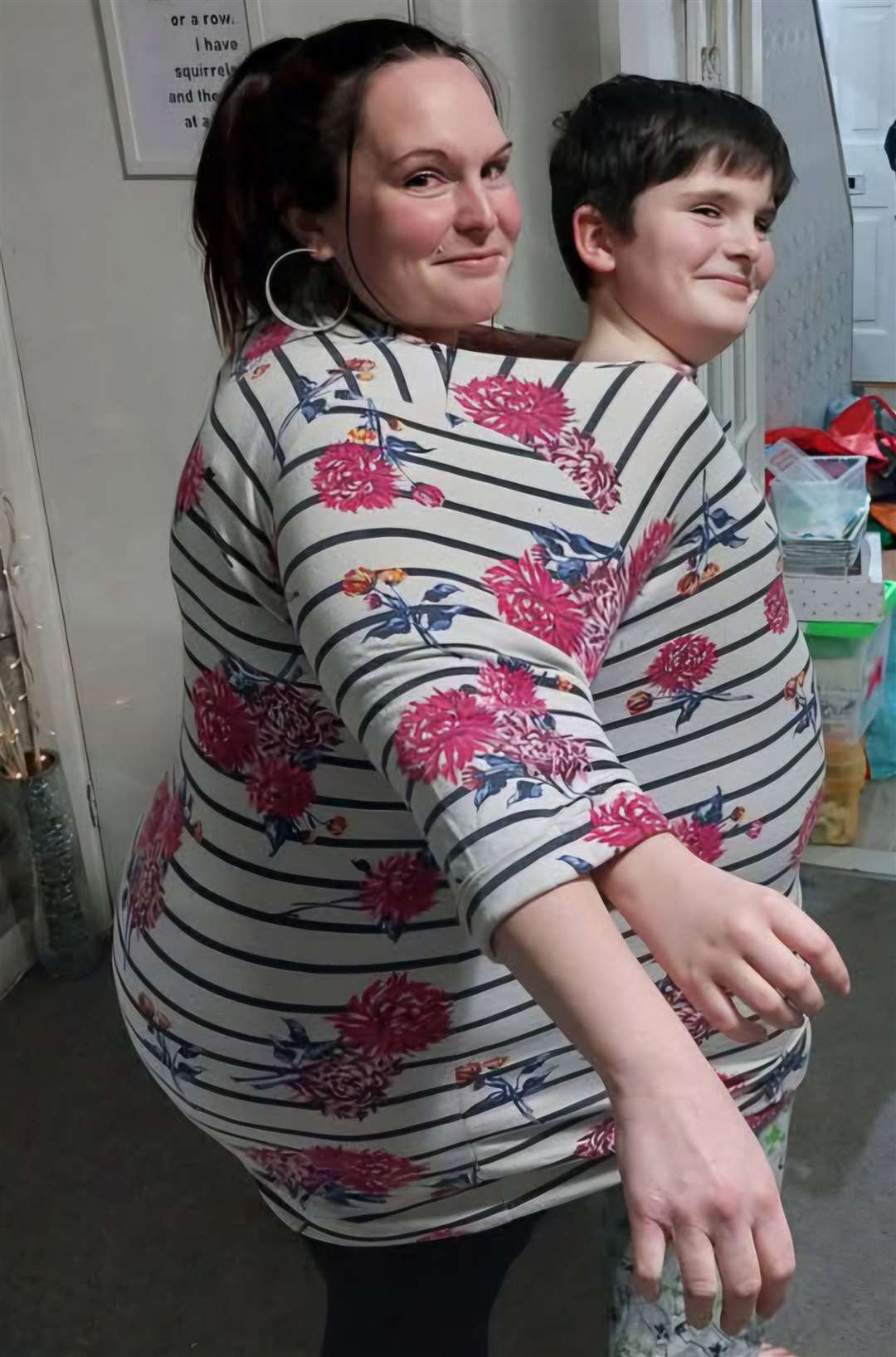 Sally Martin and her son both fit inside one of her tops from before her weight loss. Picture: SWNS