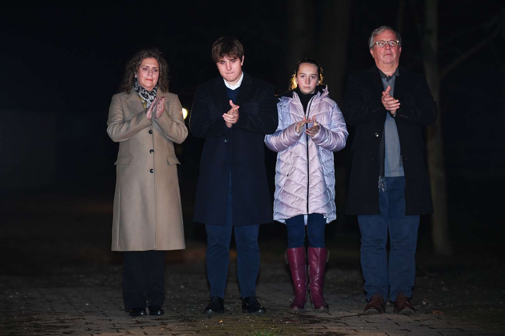 Captain Sir Tom Moore’s daughter Hannah Ingram-Moore, grandson Benji, granddaughter Georgia and son-in-law Colin Ingram outside his home in Marston Moretaine joining in with a nationwide clap in honour of the 100-year-old charity fundraiser (Joe Giddens/PA)