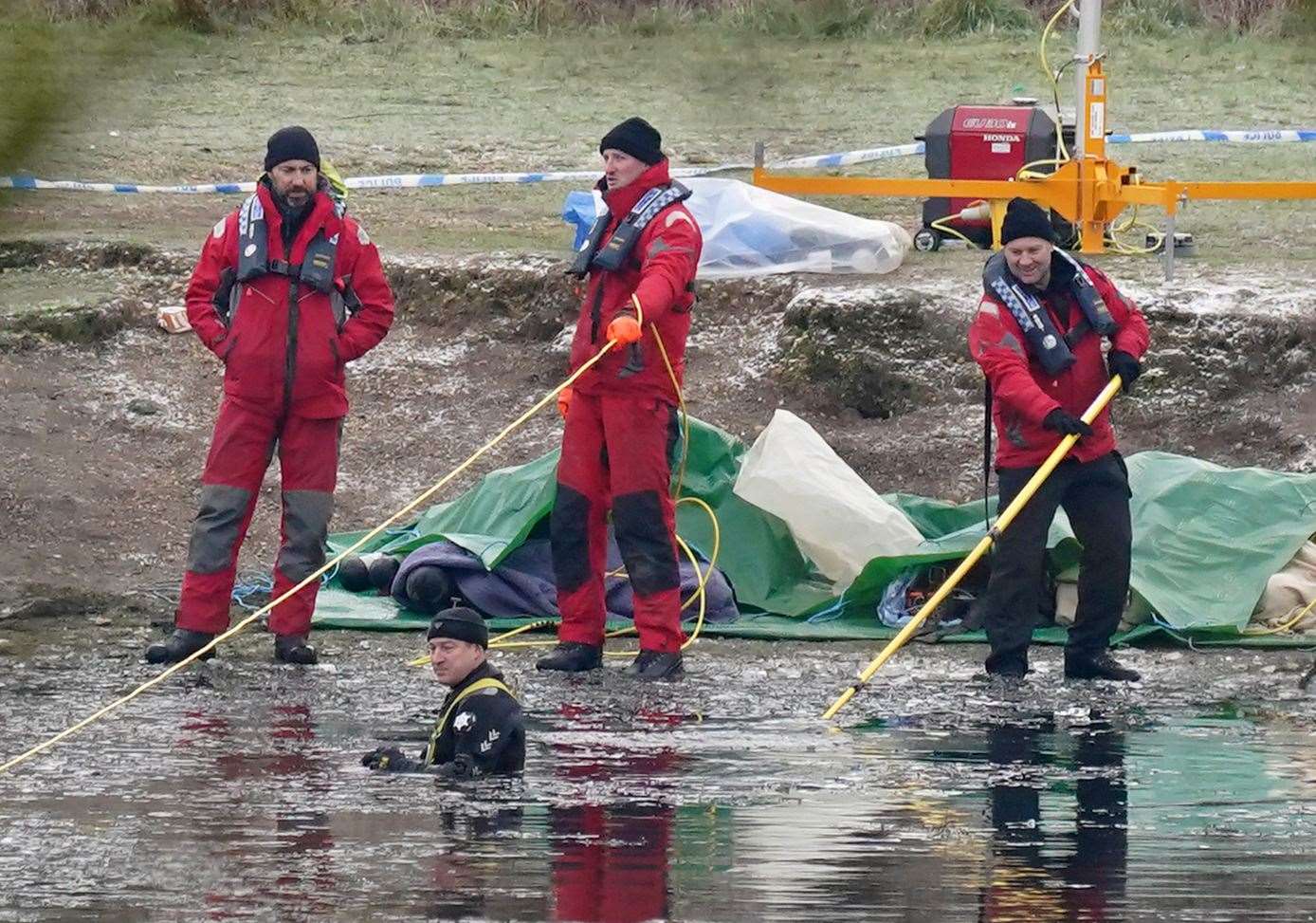 Police on the lake at Babbs Mill Park (Jacob King/PA)