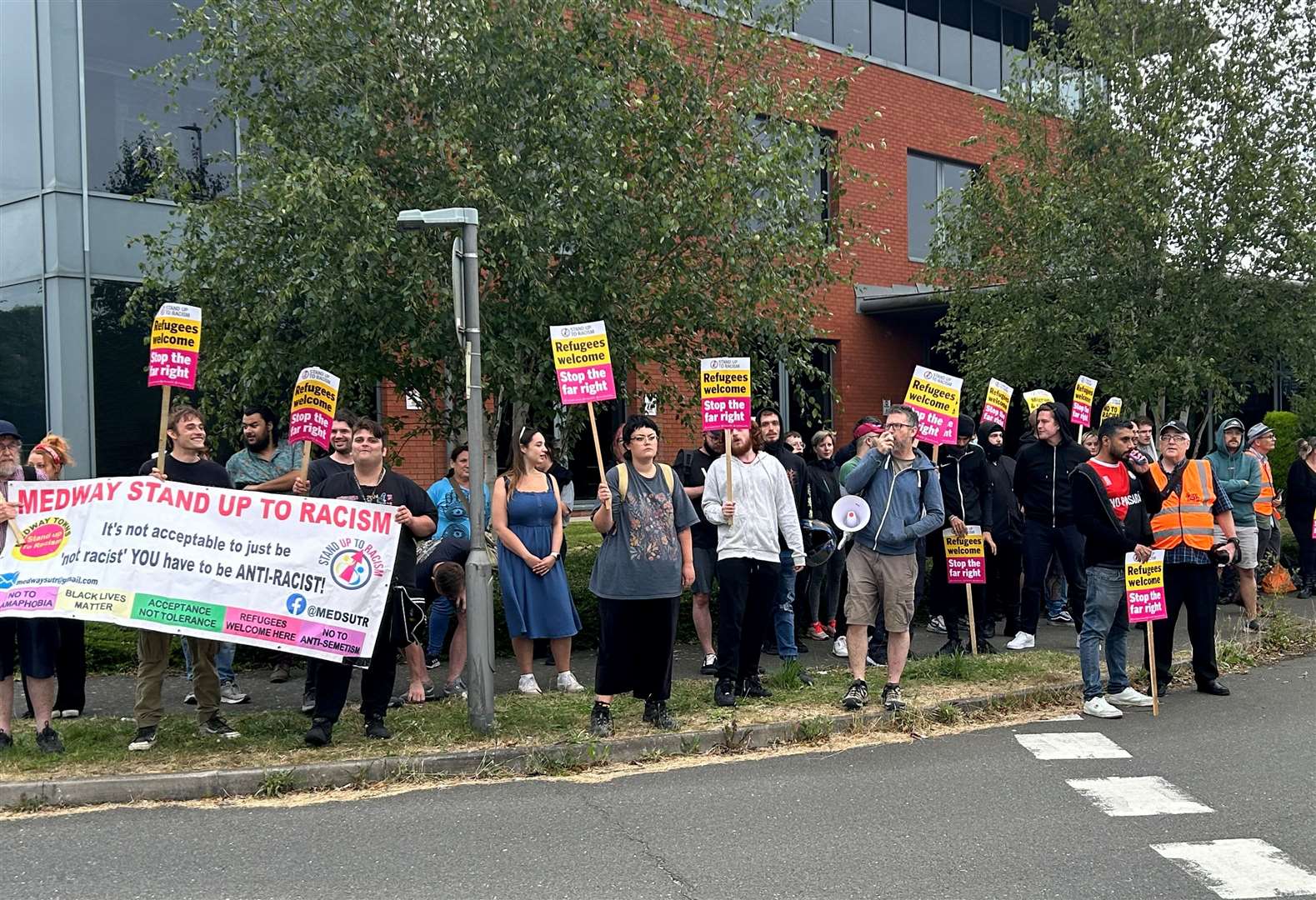 Protestors stood outside the Innovation Centre Medway in Chatham following violence across the country