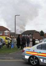 A huge plume of smoke rises from above the houses where the plane crashed