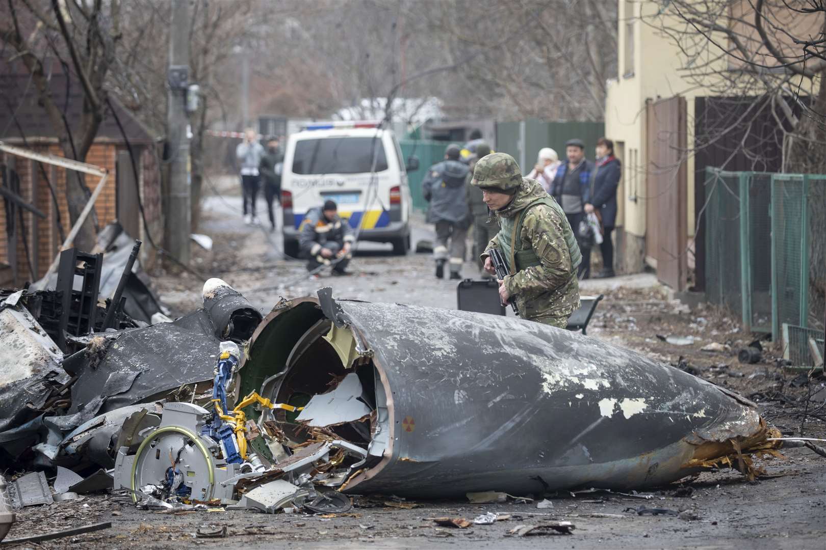 A Ukrainian army soldier inspects fragments of a downed aircraft in Kyiv, Ukraine (Vadim Zamirovsky/AP)