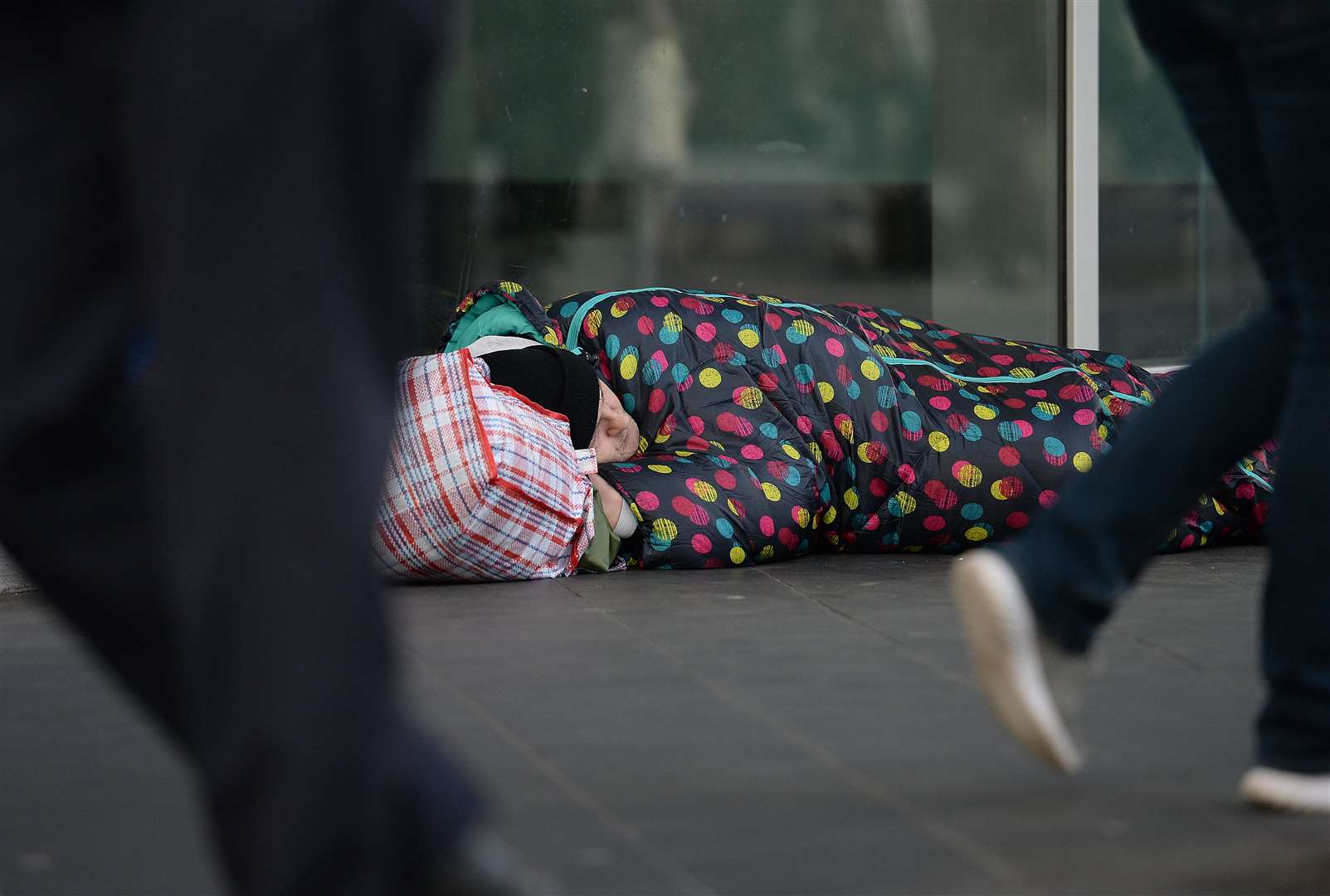 File picture of people walking past a homeless man in Victoria, London (Nick Ansell/PA)