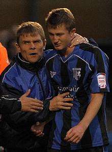 Andy Hessenthaler puts a consoling arm around youngster Callum Davies after his sending off
