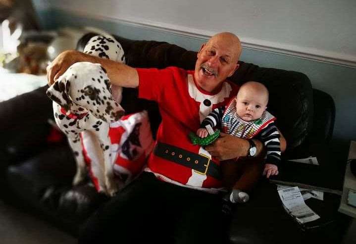 Phil Mitten with his first grandchild Isaac and his dog, May