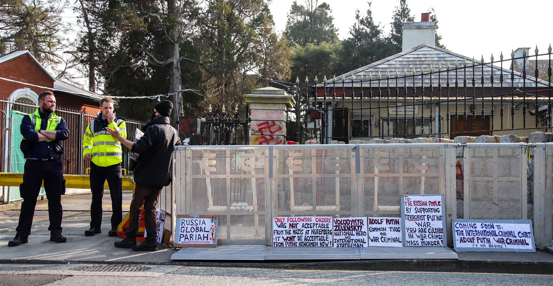 A group of protesters stand outside the Russian Embassy in Dublin with signs and Ukrainian flags following the news four senior officials at the Embassy have been asked to leave the State (Damien Storan/PA)