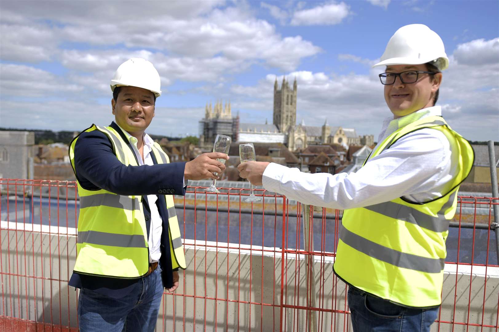 Co-directors of Slatters Development Ltd Zaw Htut and Mike Wood celebrate the topping out ceremony with champagne