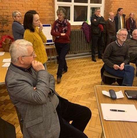 Everyone's looking thoughtful at the meeting