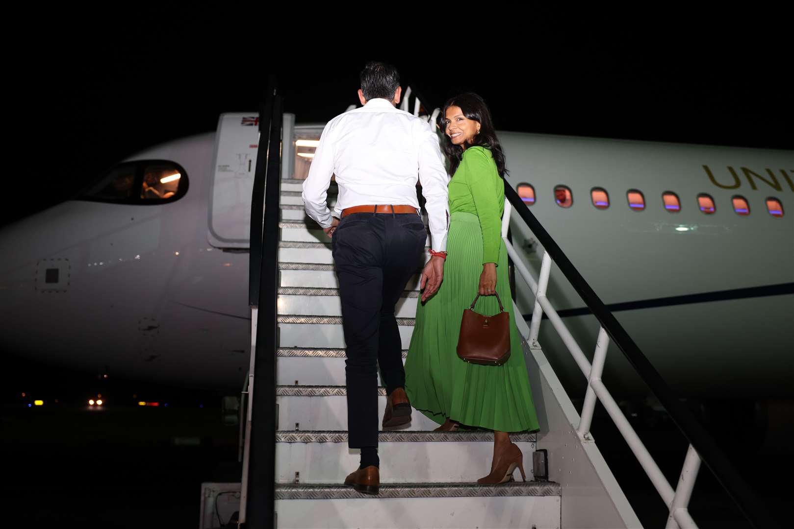 Prime Minister Rishi Sunak and his wife Akshata Murthy board the plane on their way to the G20 2023 Summit (Dan Kitwood/PA)