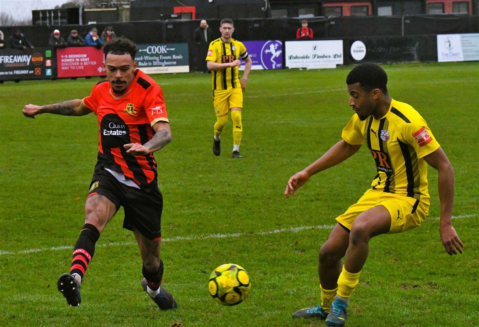 Sittingbourne’s Troy Howard attempts to play the ball past Sheppey defender Mamadou Diallo during their Isthmian South East derby. Picture: Marc Richards