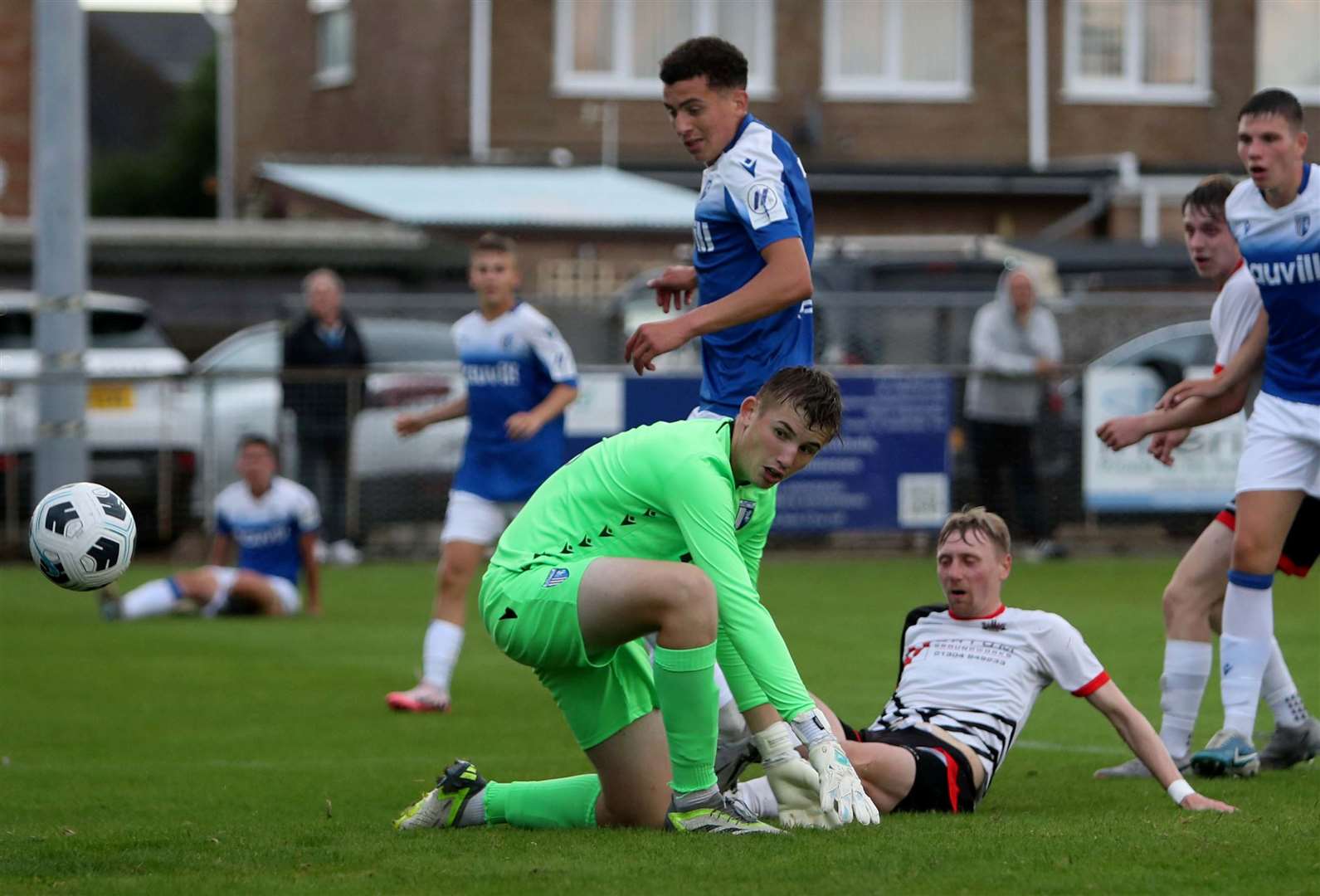 Ben Chapman gets a touch to take the ball past Gillingham goalkeeper Carter Sullivan for Deal’s opening goal at the Charles Sports Ground. Picture: Paul Willmott