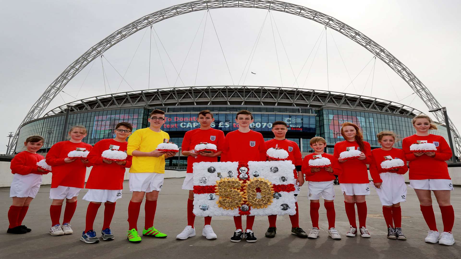 Jonjo Heuerman along with 11 other children, who represent the England 1966 World Cup winning team.