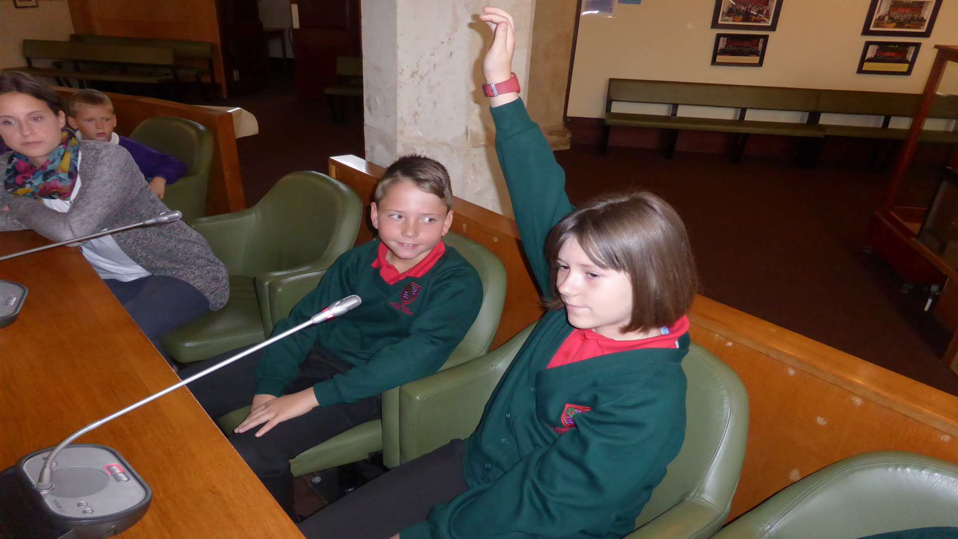 Alisha Wood, nine, of Hampton School asks the Green Champion panel a question about on Park and Stride watched by Robbie Steele, nine.