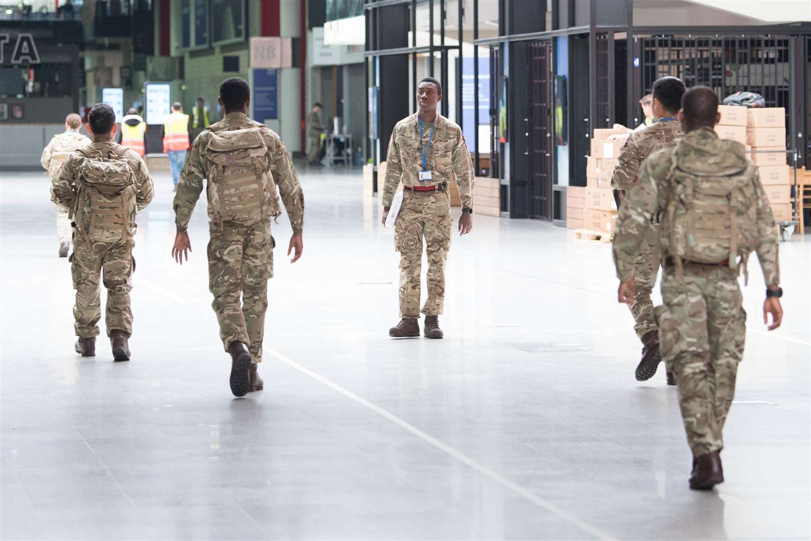 Soldiers and private contractors help to prepare the ExCel centre, London, as it was being made into the temporary NHS Nightingale hospital (Stefan Rousseau/PA)