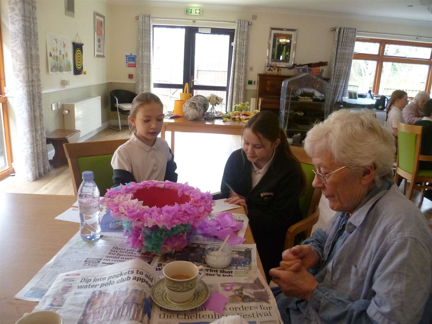 Willow and Rose with a care home resident (Joanne Bardgett/PA)