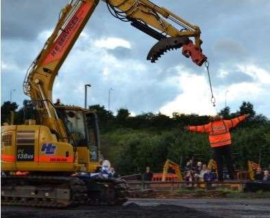 Hugh has previously hung from a excavator using only his teeth. Photo: Diggerland