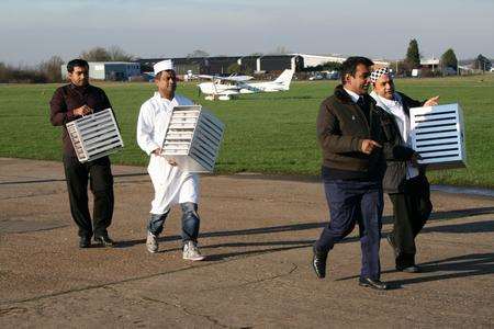 Staff at Taj Cuisine in Lower Stoke prepare to deliver Indian meal to Congo.