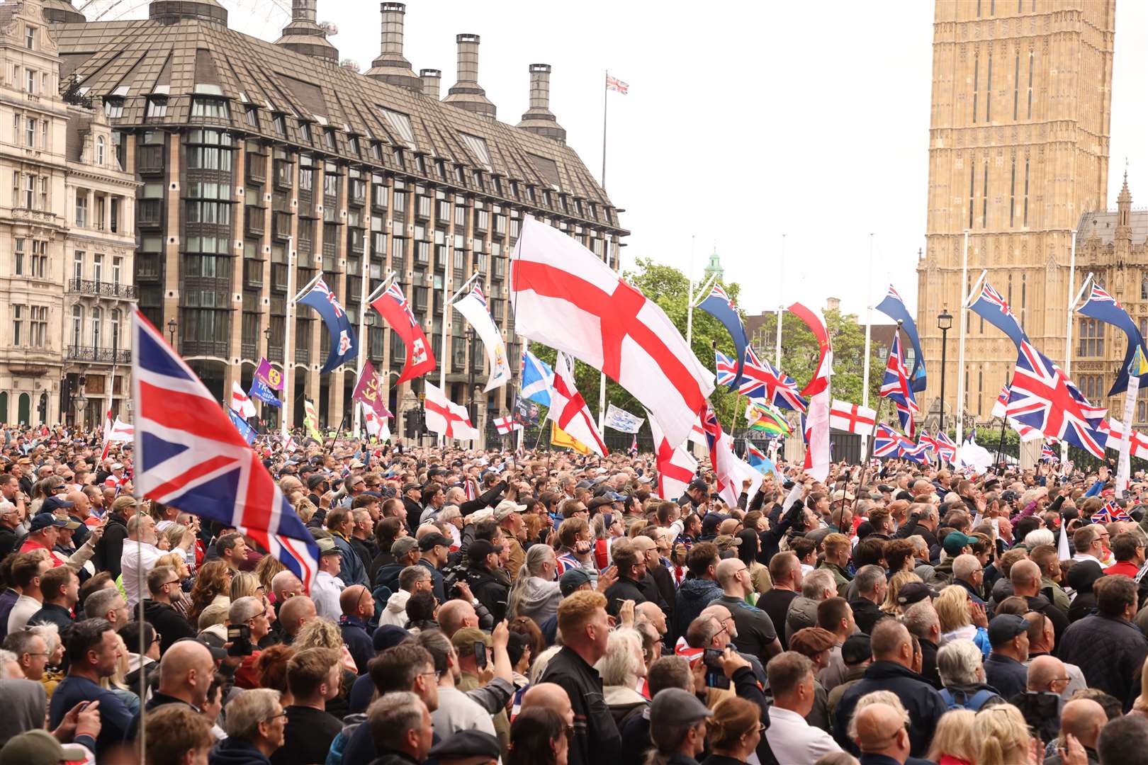 People take part in a protest march at Parliament Square in London, organised by Tommy Robinson, in June ( David Parry/PA)