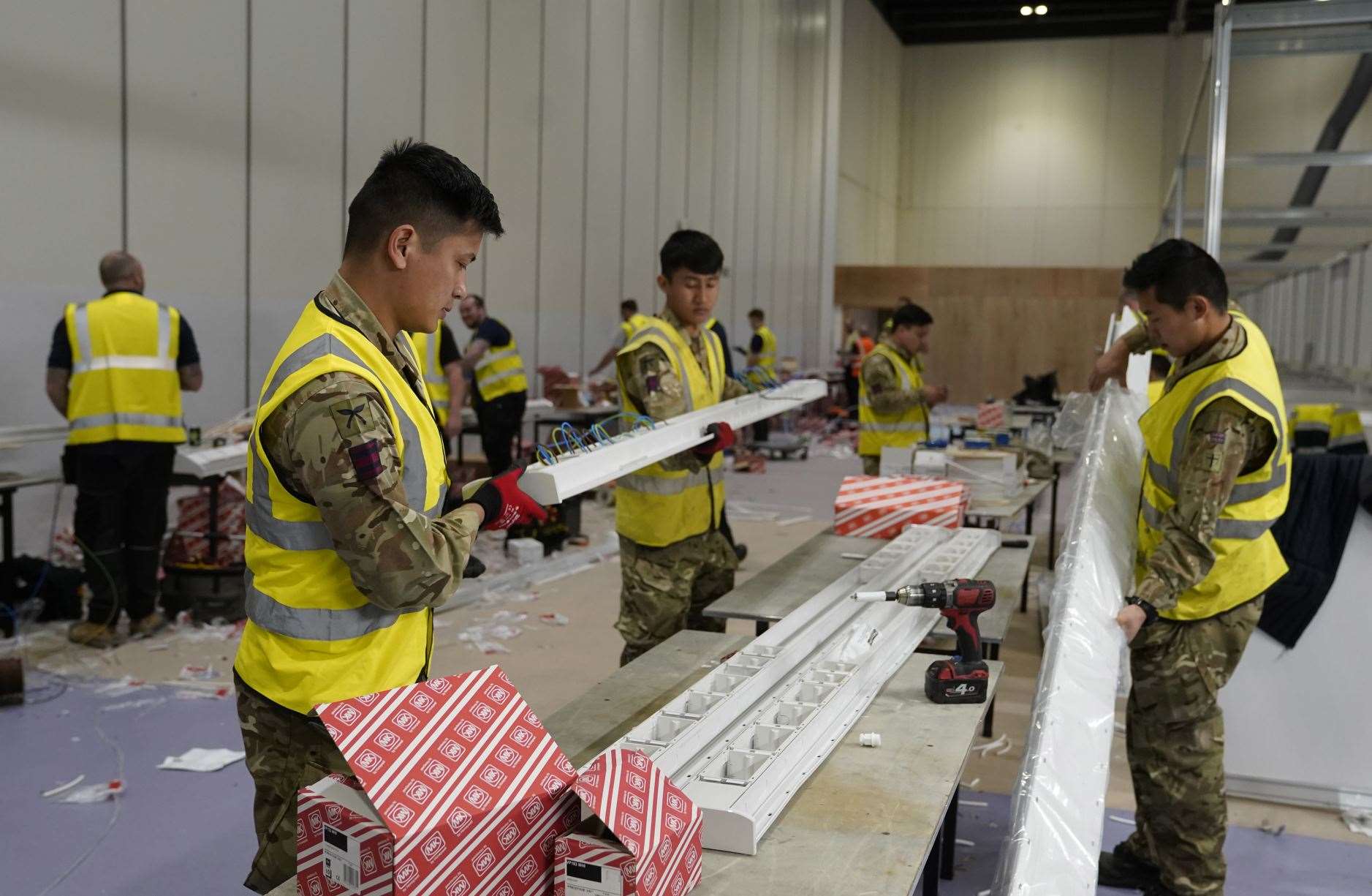 Members of the Queen’s Gurkha Engineer Regiment help build a Nightingale Hospital