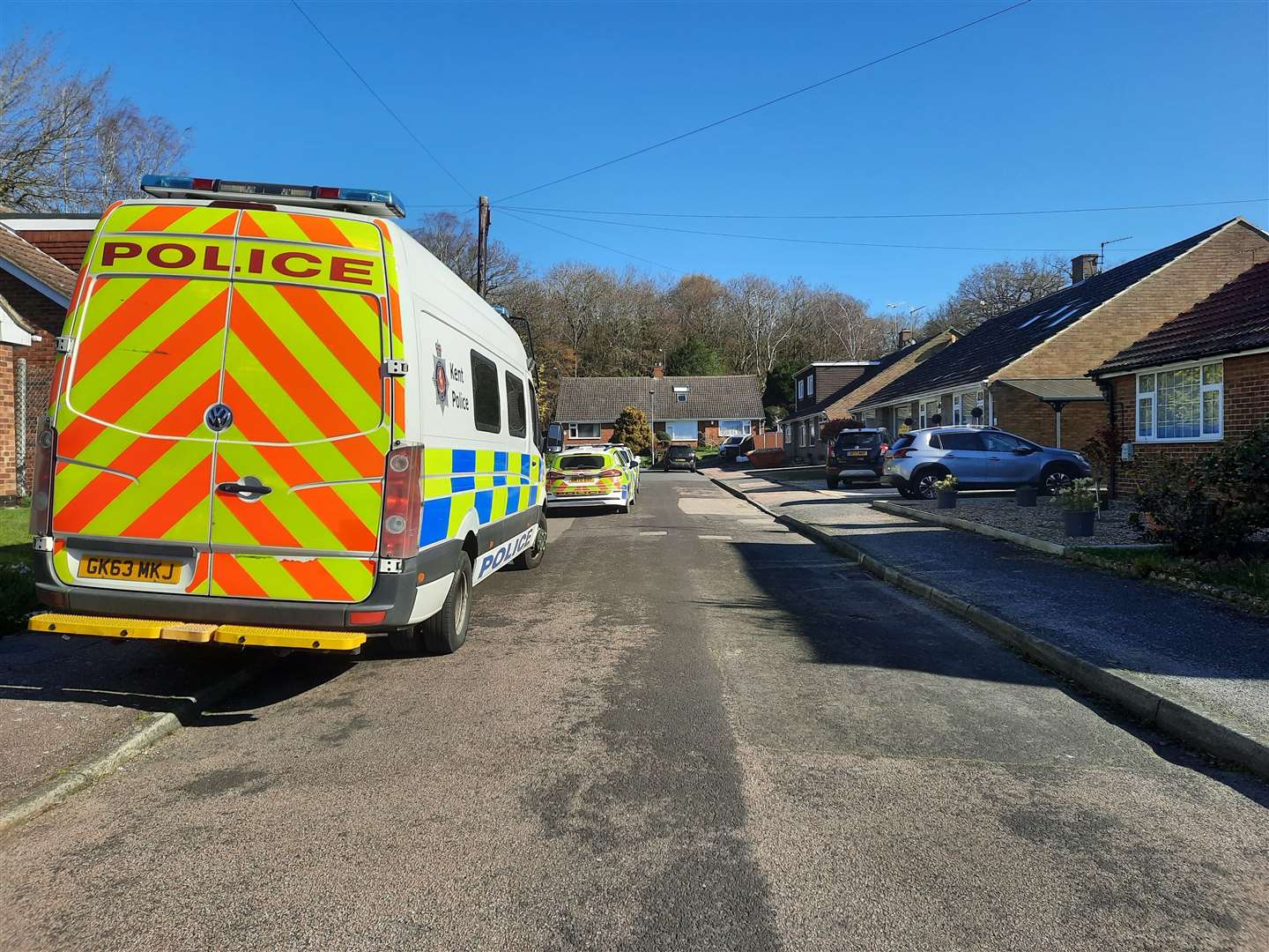 Neighbours say they saw several police officers "sprinting" along Laburnum Lane before storming the home