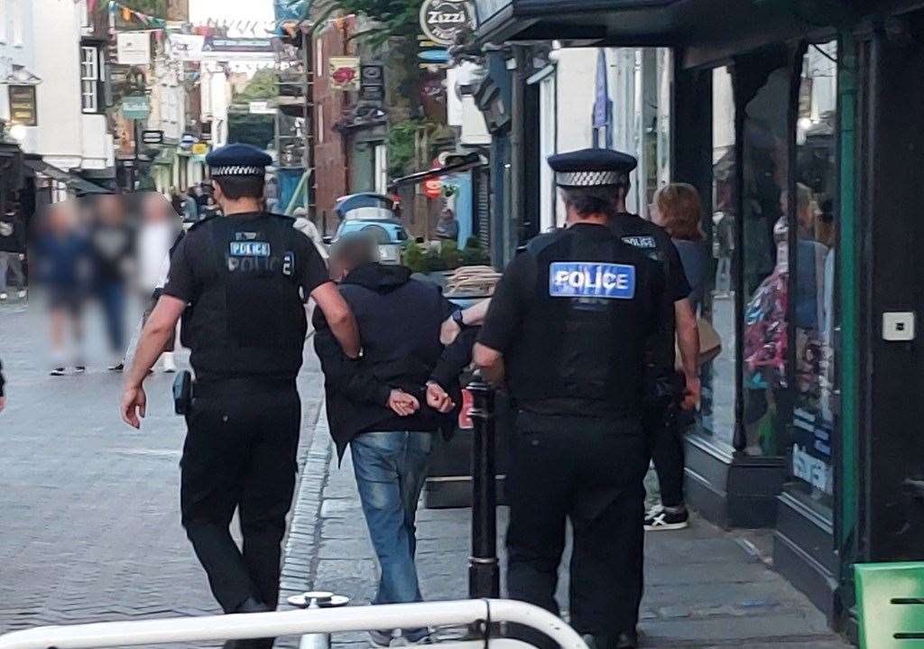 A man was arrested and pictured in St Peter's Street, Canterbury, on suspicion of breaching court bail not to enter the city centre between 7pm and 7am. Picture: Kent Police