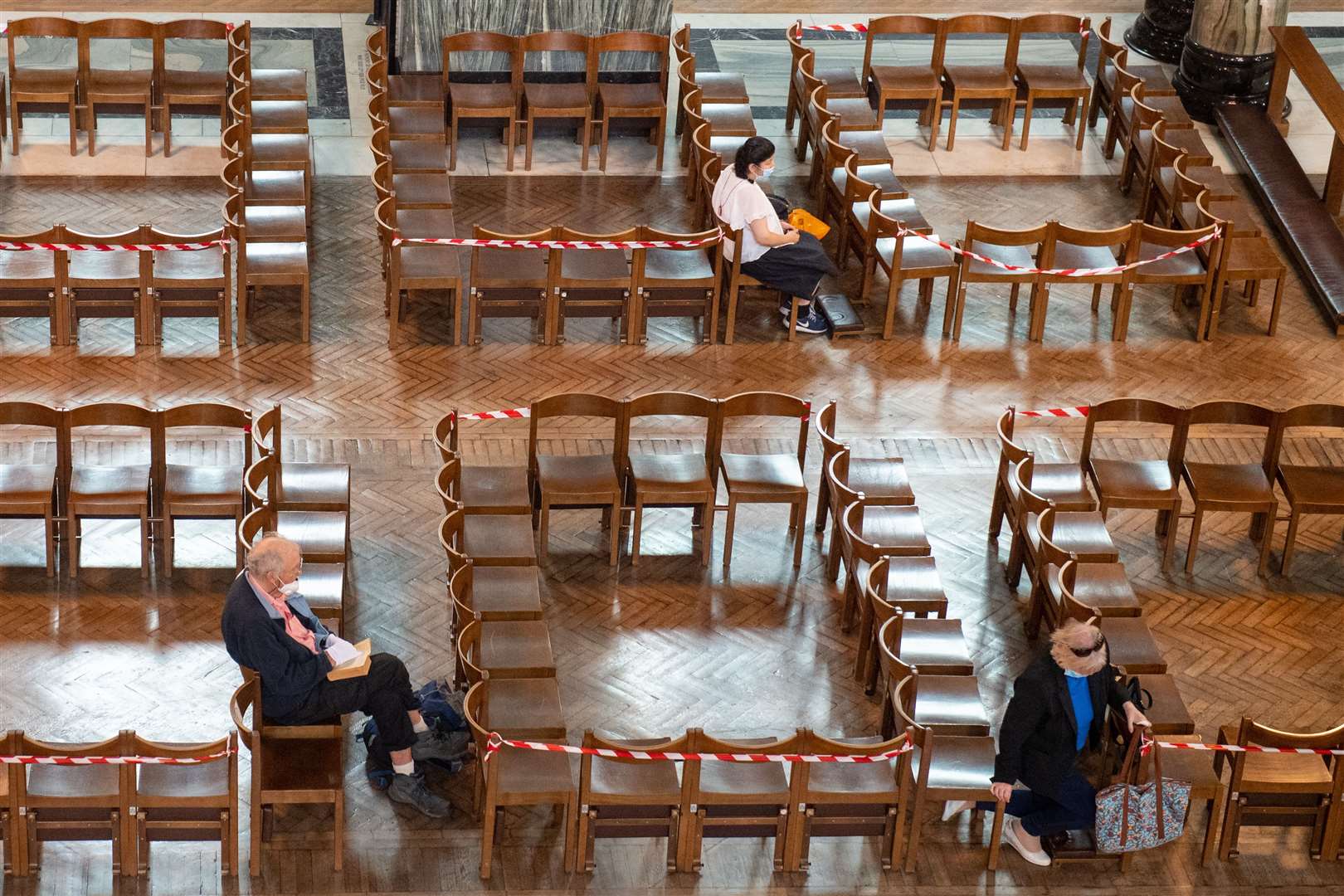 Worshippers on seats arranged for social distancing at Westminster Cathedral, London ( Dominic Lipinski/PA)