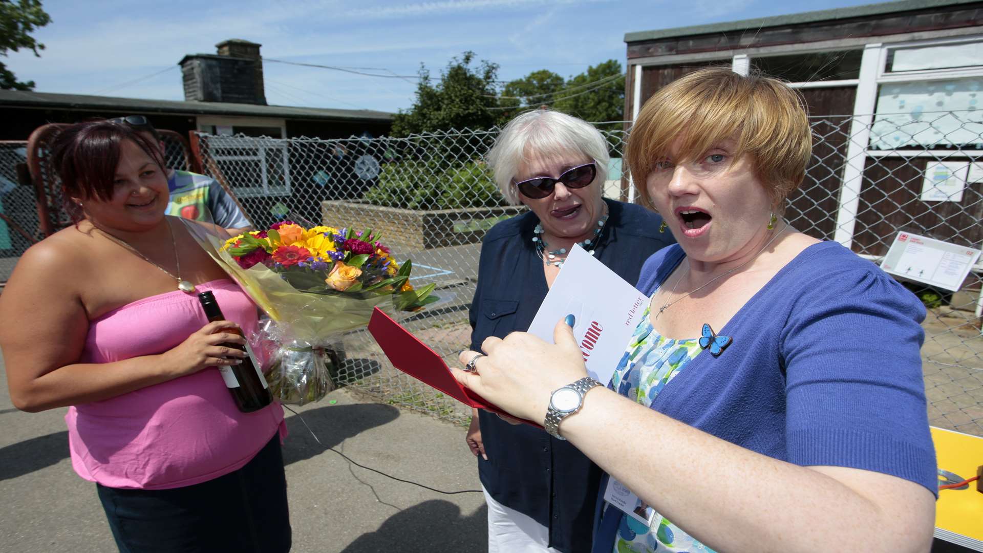 Head teacher Jo Cerullo recieves a gift from her staff at a summer picnic