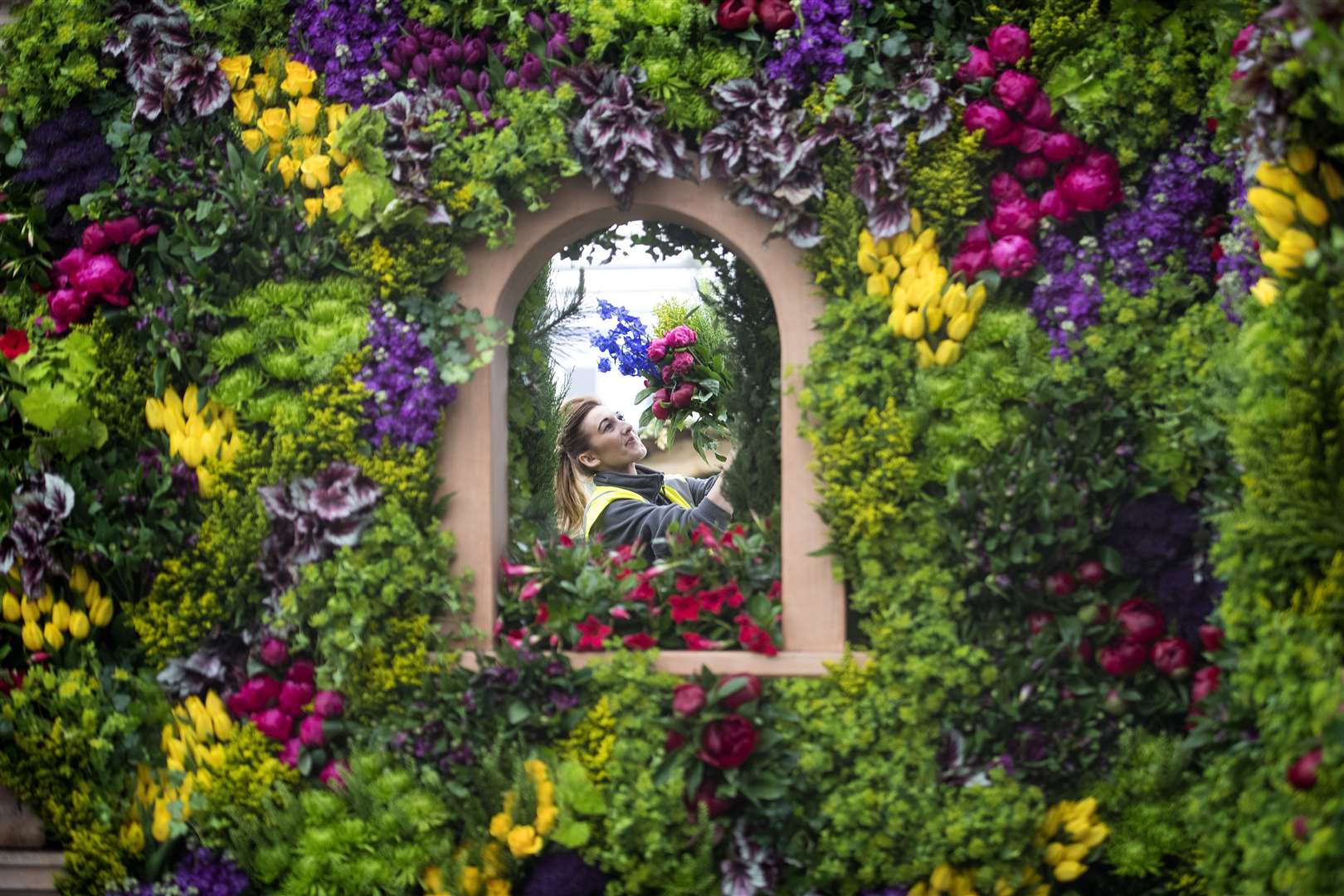 Becky Frost making the final floral arrangements on the Marks and Spencer display in 2017 (PA)