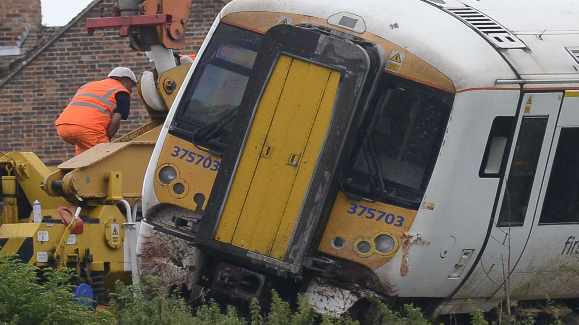 Workmen remove gravel to find the rail. Picture: Paul Amos.